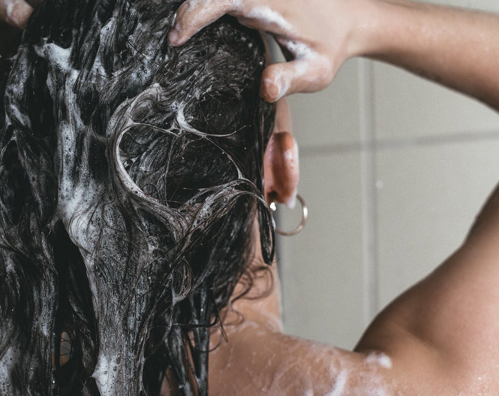 Byrdie | How to Wash Your Hair Without Clogging the Drain